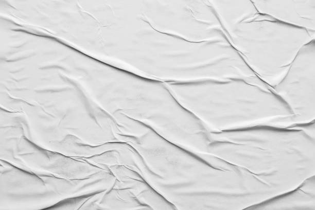 istock Blank white crumpled and creased paper poster texture background 1295877154