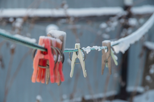 clothespins on a rope under the snow