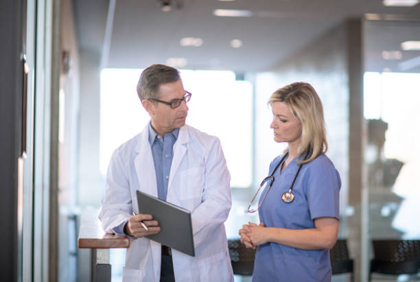 istock Doctor and nurse working together 1295878612