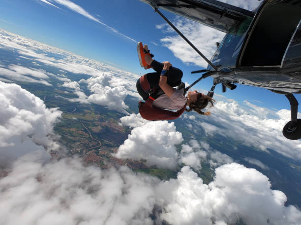 istock Young woman skydiver jumping from the plane 1295879345