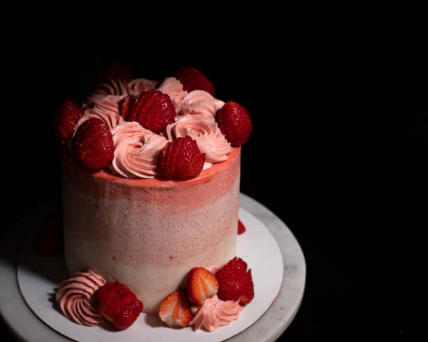 istock Strawberries and Cream Cake on Marble Cake Stand 1295880407