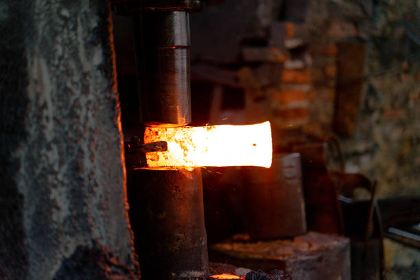 istock The blacksmith is forging very hot iron to make various tools. 1295889031
