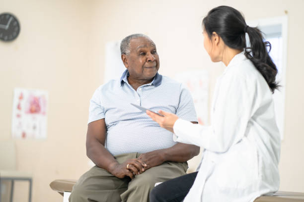 istock Senior man at doctor's office 1295890788