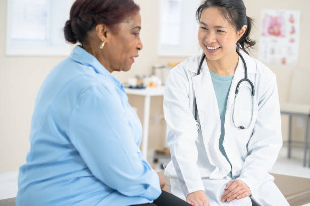 istock Female Asian doctor with patient 1295890817