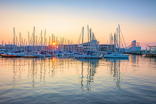 Marina with sailboats at Port Vell in downtown Barcelona, Catalonia, Spain at sunrise.