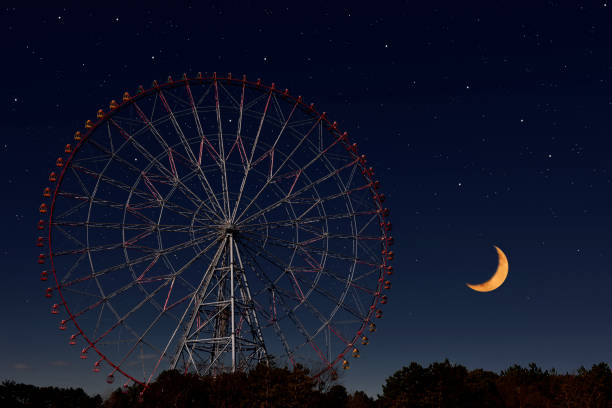 istock Crescent moon rising over the Ferris Wheel 1295896555