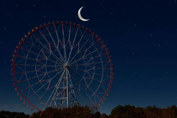 Crescent moon rising over the Ferris Wheel