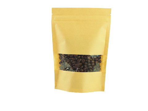Coffee beans in brown kraft transparent window paper bag with zipper isolated on a white background.