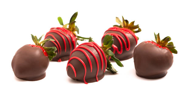 istock Chocolate Covered Strawberries with Red Drizzle Isolated on a White Background 1295896799