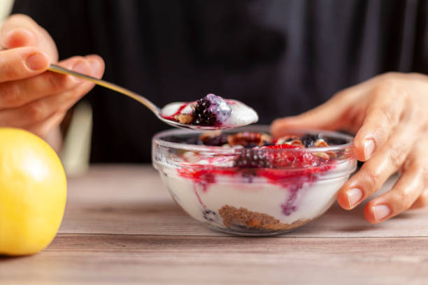 istock eating yogurt parfait with berries and an apple 1295896947
