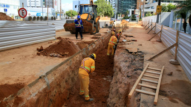 civil construction worker salvador, bahia, brazil - january 6, 2021: OAS contractor workers are seen working on excavating a street in the Pituba neighborhood in the city of Salvador. trench stock pictures, royalty-free photos & images