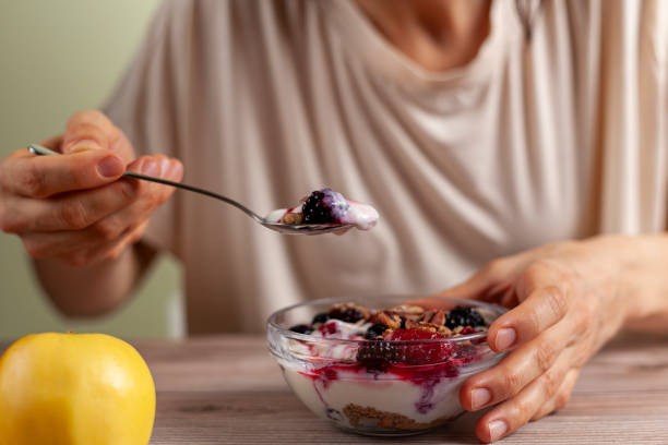 istock eating yogurt parfait with berries and an apple 1295896984