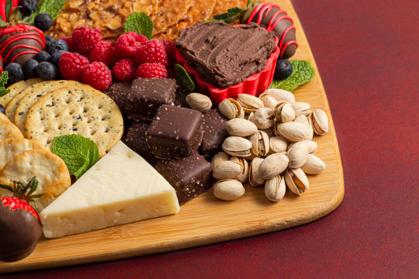 istock Chocolate Covered Strawberries and Cheese Sweet Charcuterie Board on a Red Table 1295897020