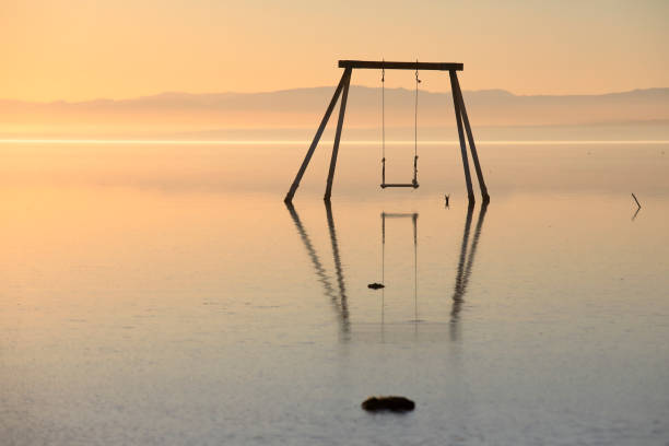 istock The swing in the water during the sunset 1295898585