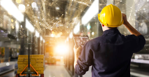 istock Factory engineer hold tablet manage inventory control and delivery smart transportation through intelligent warehouse management system.Global logistic contribution and industrial innovative. 1295904711