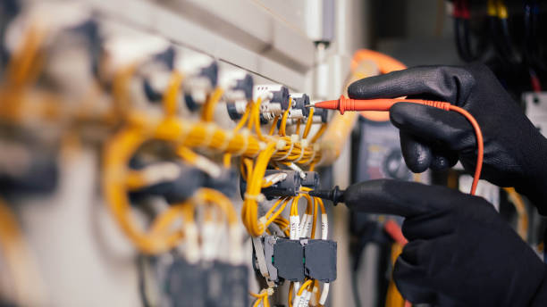 istock Electrician engineer work tester measuring voltage and current of power electric line in electical cabinet control.and wires on relay protection system. Bay control unit. Medium voltage switchgear. 1295906397