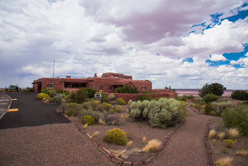 Petrified Forest National Park, painted desert, nature, desert plants in the front, the painted desert inn in the distance and overcast cloud. Arizona, August 2020