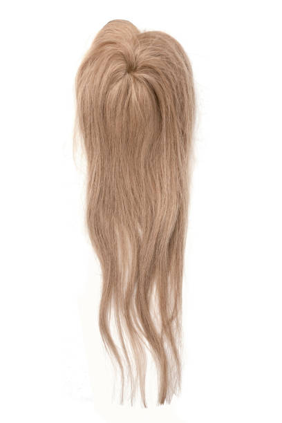 istock A light blond long wavy wig or hair topper on a white background. 1295910906