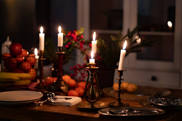 istock candlesticks with candles on wooden table.romantic setting for dinner in kitchen 1295913616
