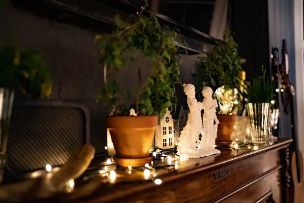 Photo of white figurines of children singing Christmas songs on the piano. New Year