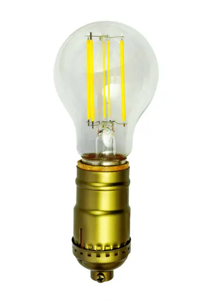 A vintage style bronze bulb-holder with a switch as a chain and Edison-bulb style