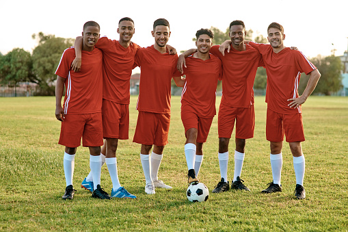 Shot of a group of young soccer players standing together on a sports field