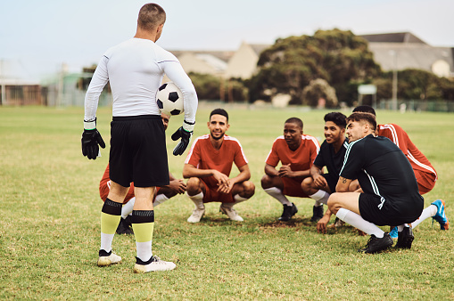 Shot of a team of soccer players having a discussion on the field