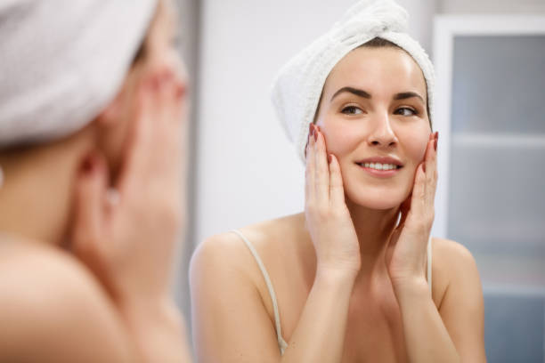 istock Woman looking herself in mirror 1295917874