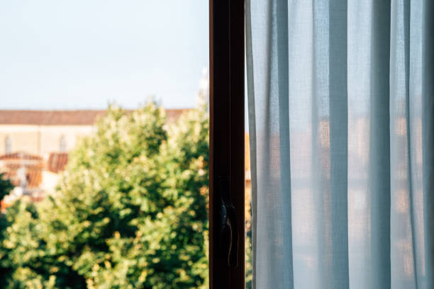 istock View of green trees from open window 1295918919