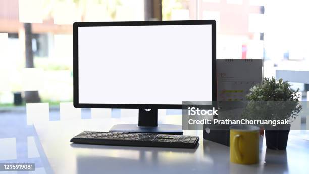 Front View Computer With White Screen Coffeecup Plant And Calendar On White Table Stock Photo - Download Image Now