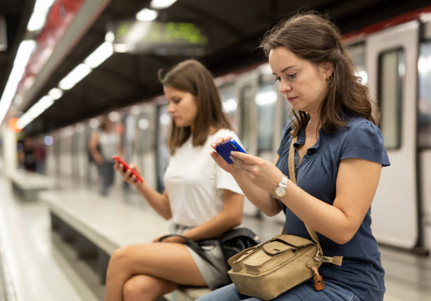 istock Young woman with phone on subway station 1295920387