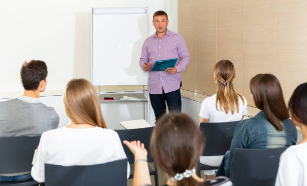 istock Man reading out report to colleagues 1295922559