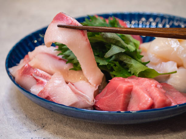 Assorted fresh yellowtail and tuna sashimi. Close up of fresh yellowtail. Assorted fresh yellowtail and tuna sashimi. Close up of fresh yellowtail. shiso photos stock pictures, royalty-free photos & images