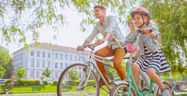 istock Family riding bicycle 1295928684