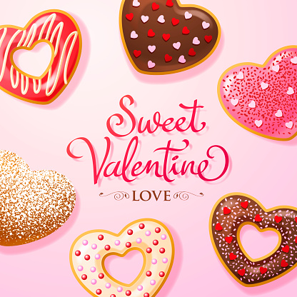 Group of heart shaped donuts coated with colorful sprinkles and powdered sugar for the Valentine's Day treats