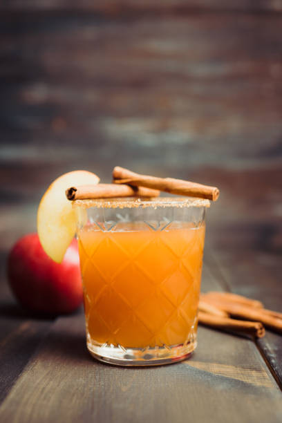 Old-fashioned cocktail based on freshly squeezed apple juice with cinnamon spices. Drinks and beverages. Selective focus. Shallow depth of field.