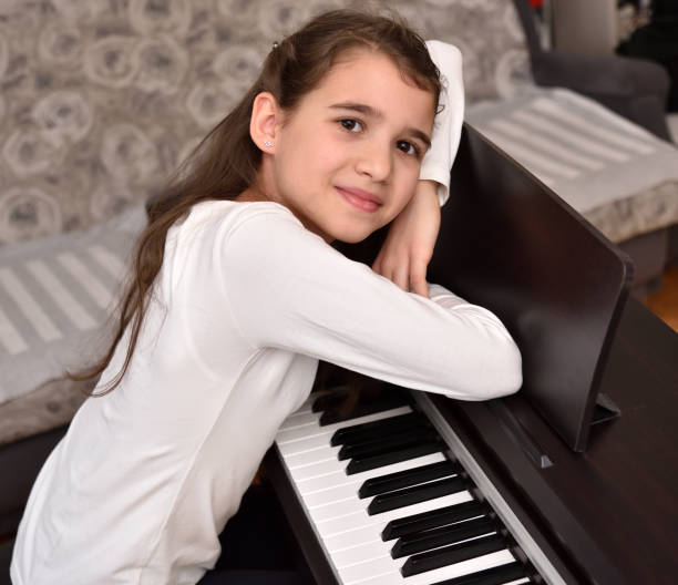 istock Young girl and her piano 1295931084