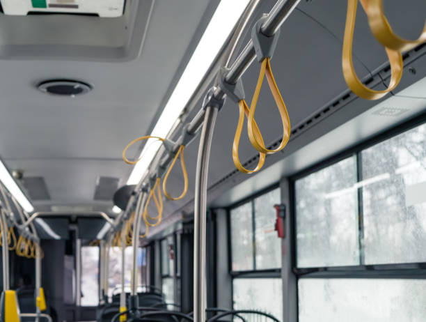 istock Interior of a empty bus with many hand holders or grips on the handle bar 1295931484