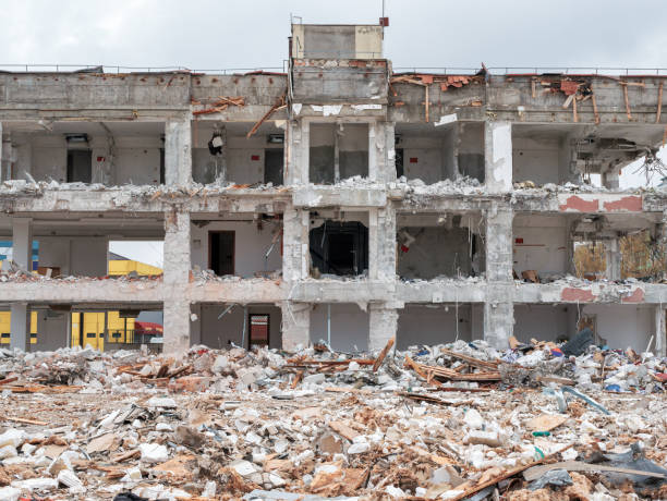 istock Building being demolished in Bucharest, Romania. Concrete remains and rubble on a construction site 1295931496