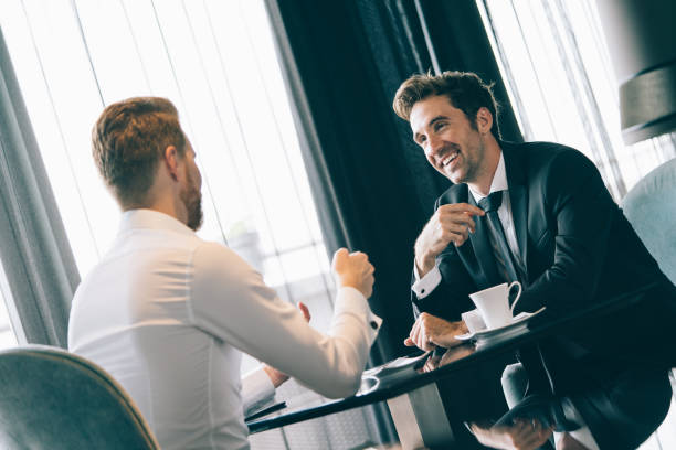 istock Handsome two businessmen have a meeting in cafe 1295931576