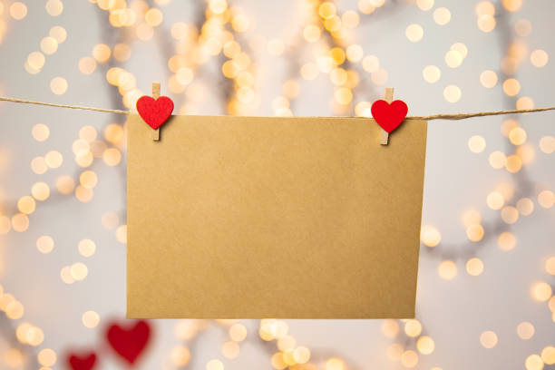 istock Blank letter, envelope or greeting card hanging with red hearts, romantic love letter , Valentines Day concept bokeh background, copy space 1295932496