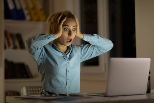 Shocked woman at night Shocked woman at night shocked computer stock pictures, royalty-free photos & images
