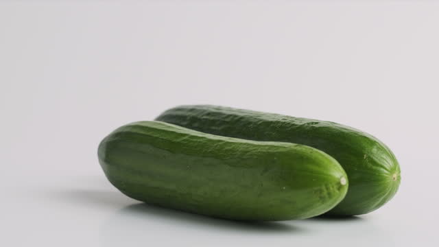 Cucumber turn on white platform background