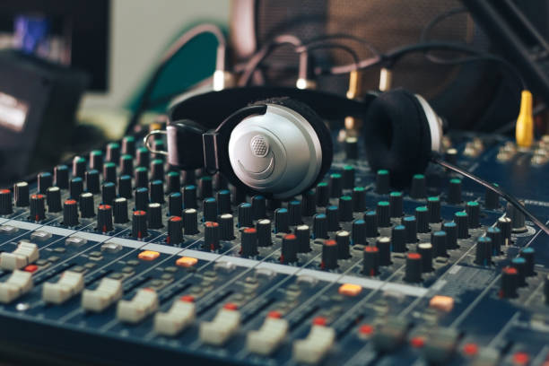 istock Silver headphones on a Studio audio mixer. 1295934161