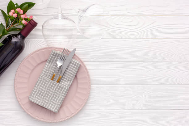 istock Romantic dinner concept.Romantic valentine's day table setting with wine, glasses and red box 1295935454