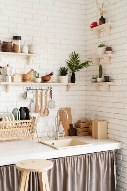 istock Rustic kitchen interior with white brick wall and white wooden shelves 1295936640