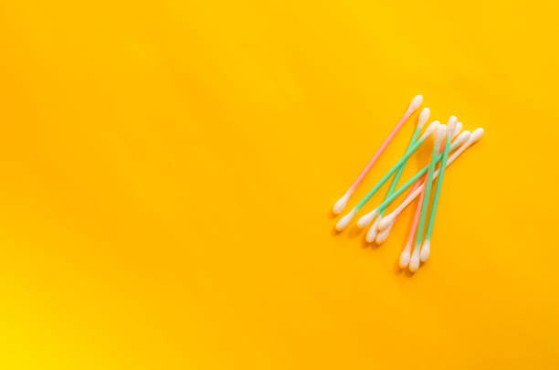 istock Minimalist background with cotton swabs on a yellow background. 1295936694