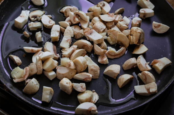 istock Raw mushrooms are fried in a pan. 1295936783