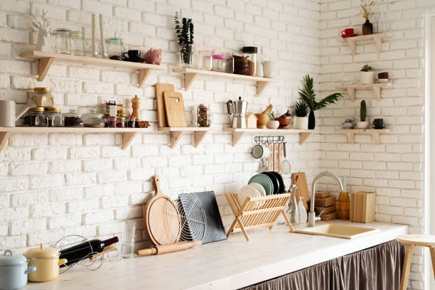 istock Rustic kitchen interior with white brick wall and white wooden shelves 1295936858