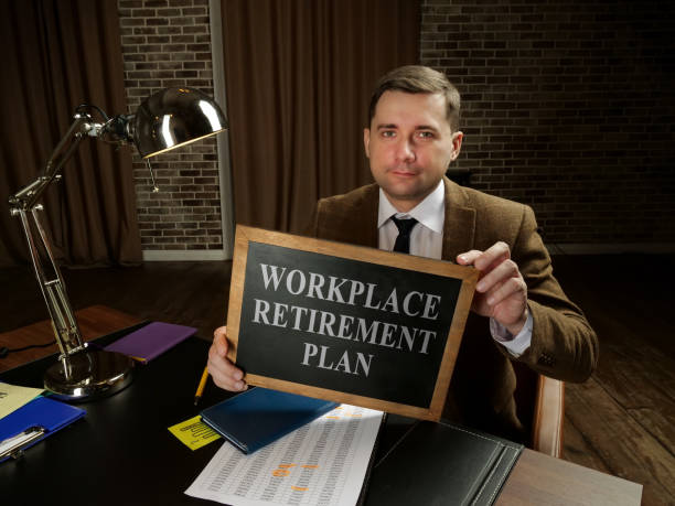 istock Workplace retirement plan concept. The manager holds a sign with the inscription. 1295937969